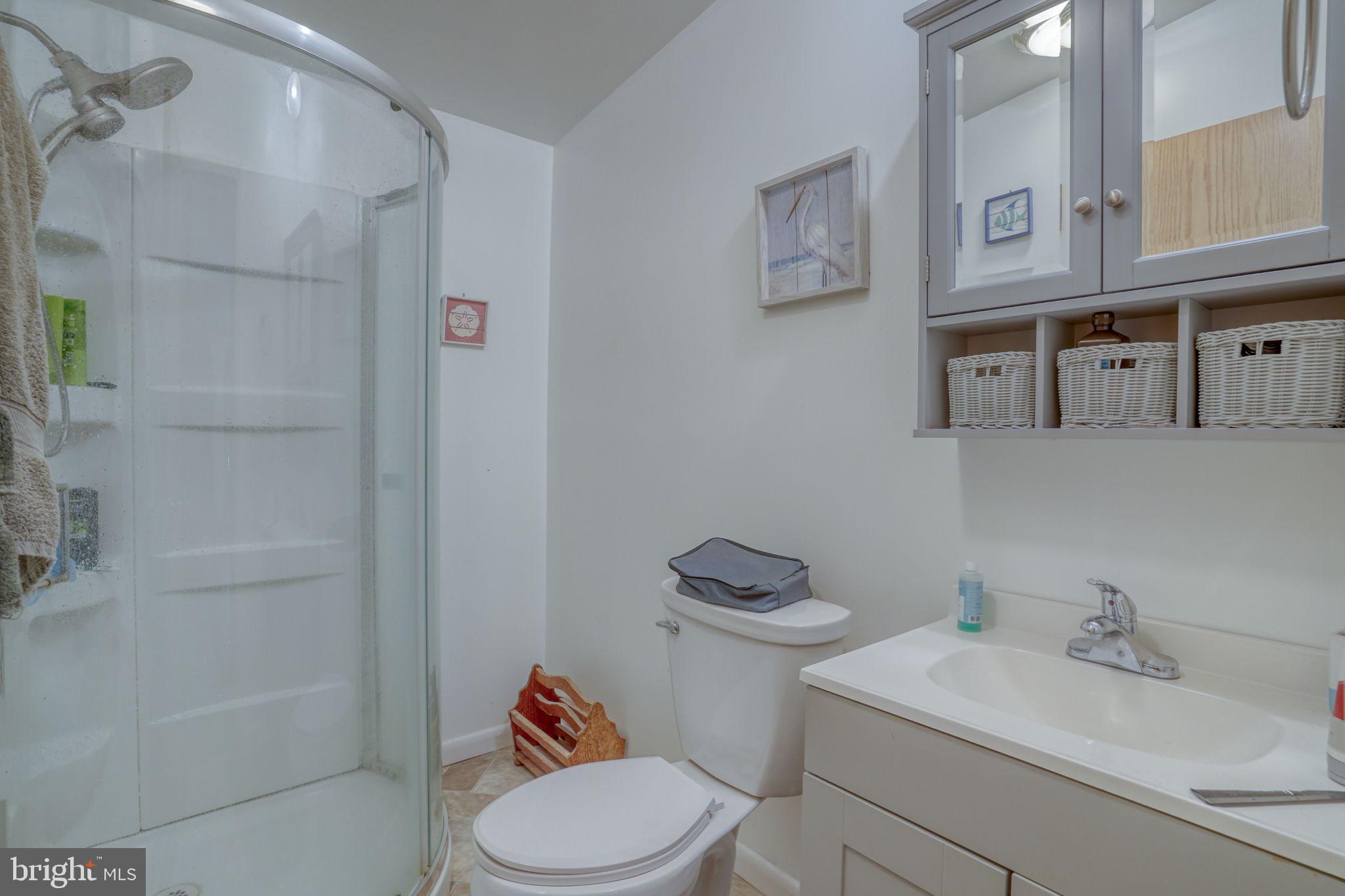 1679 South State Street, Unit A55 Dover, DE 19901 - Photo 21 of 26 a white toilet sitting next to a bathroom sink