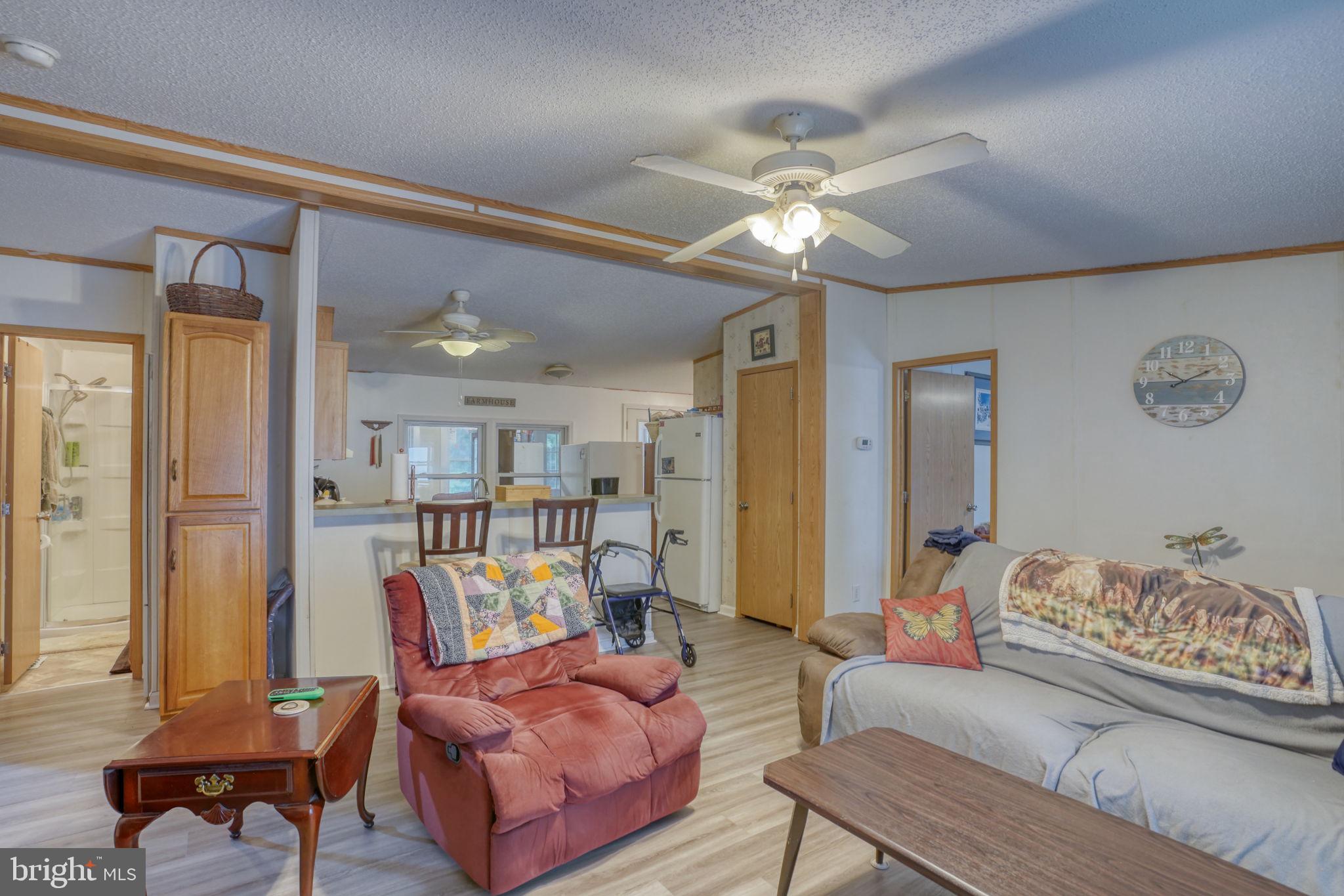1679 South State Street, Unit A55 Dover, DE 19901 - Photo 5 of 26 a living room with furniture and a chandelier