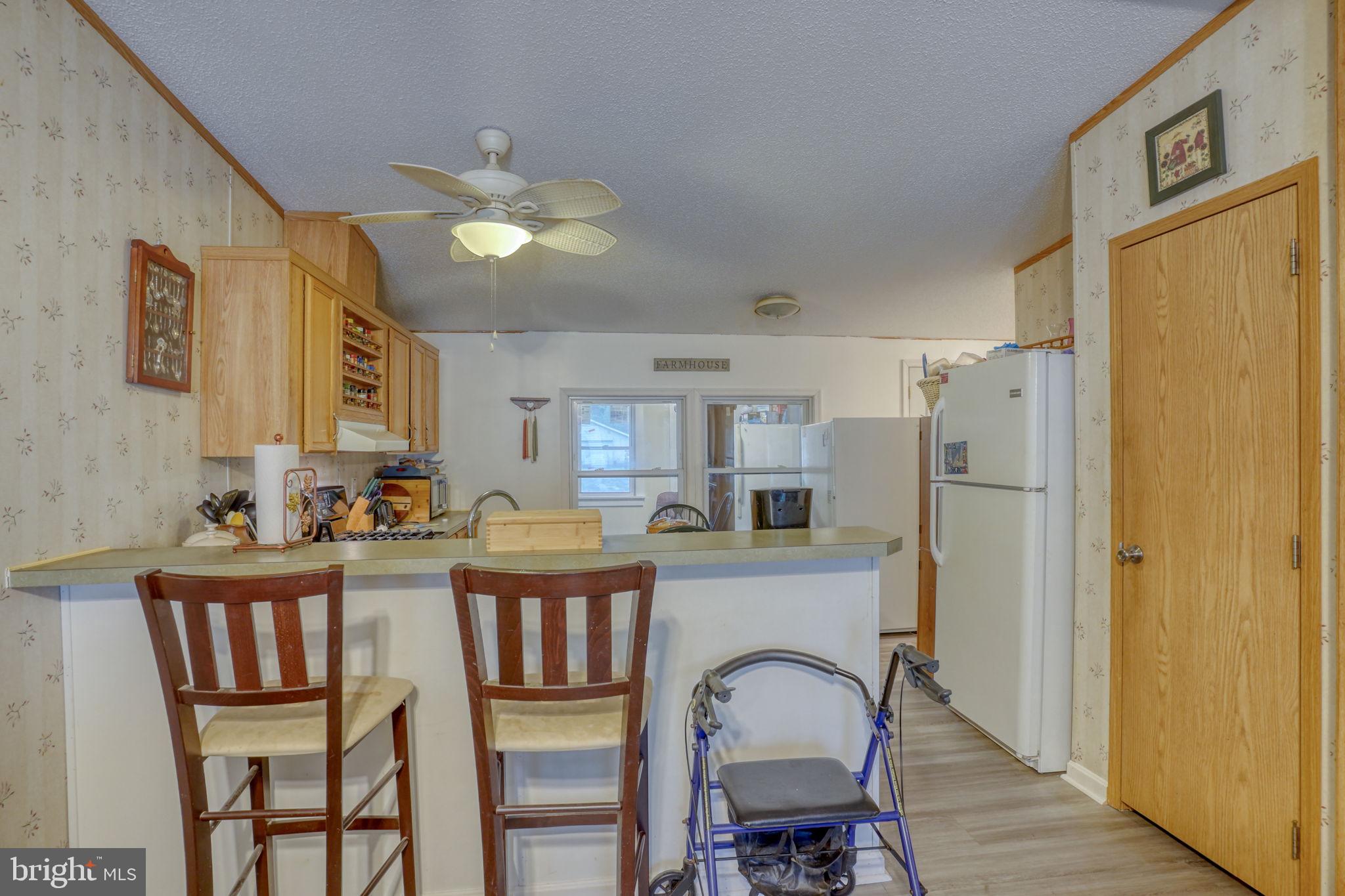1679 South State Street, Unit A55 Dover, DE 19901 - Photo 6 of 26 a view of a dining room with furniture and chandelier fan