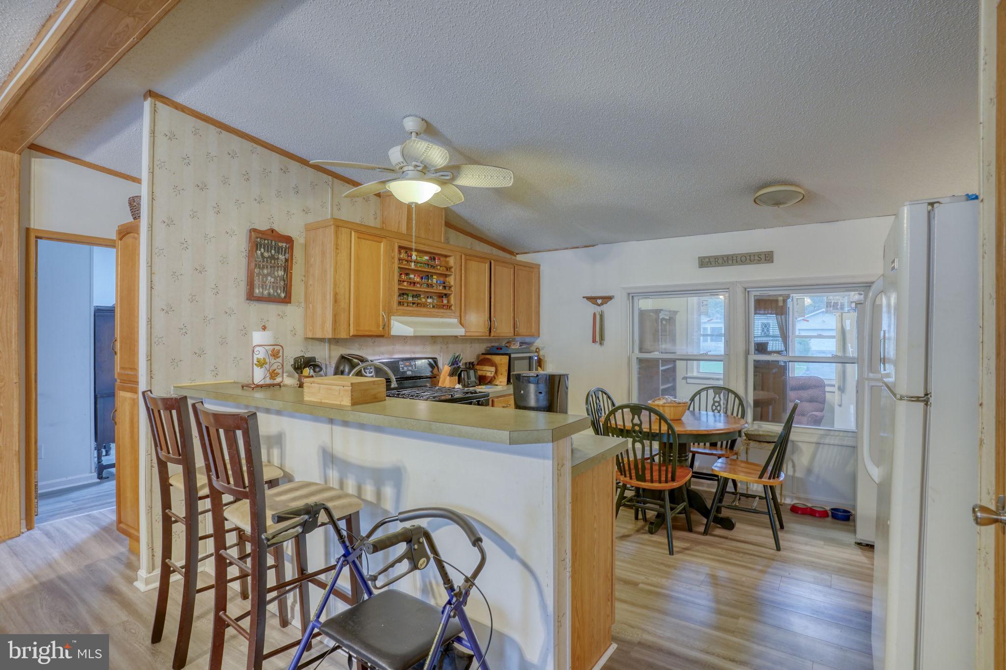 1679 South State Street, Unit A55 Dover, DE 19901 - Photo 7 of 26 a view of a dining room with furniture and wooden floor