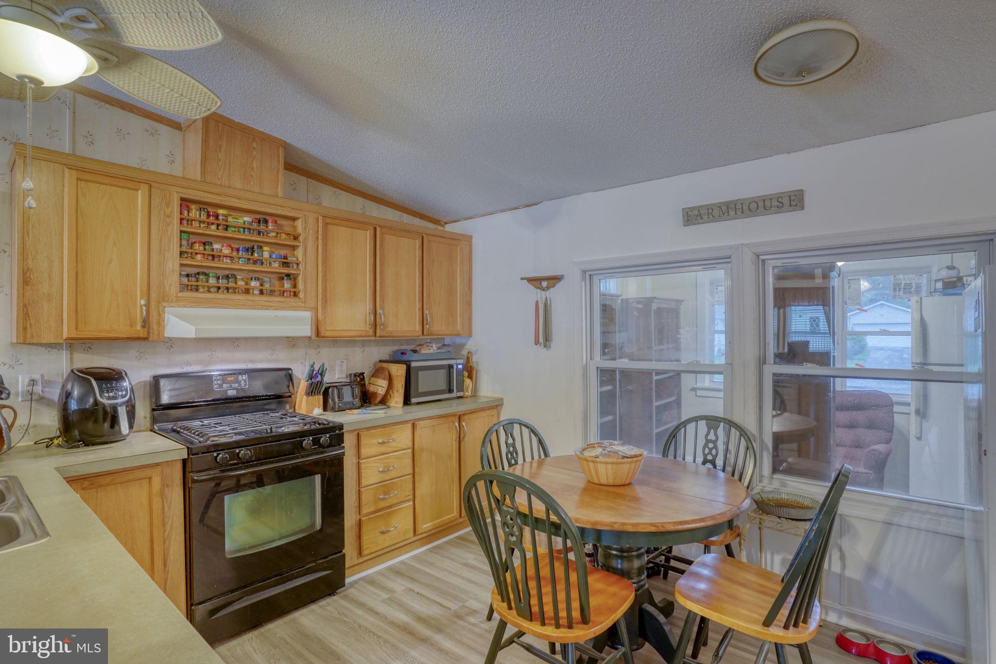 1679 South State Street, Unit A55 Dover, DE 19901 - Photo 8 of 26 a kitchen with stainless steel appliances a stove a table and chairs