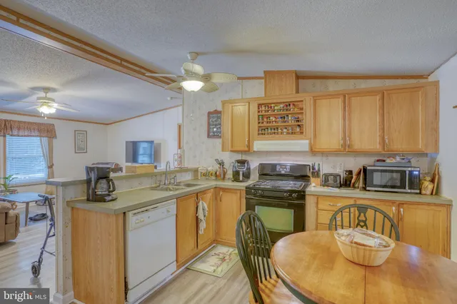 a kitchen with stainless steel appliances granite countertop a sink and cabinets