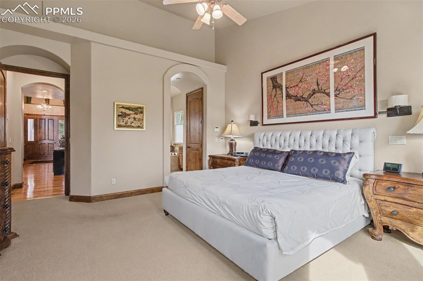 870 Mont Blanc View Colorado Springs, CO 80906 - Photo 17 of 42 Spacious and sophisticated, the primary bedroom boasts an adjoining walk-in closet and bathroom.