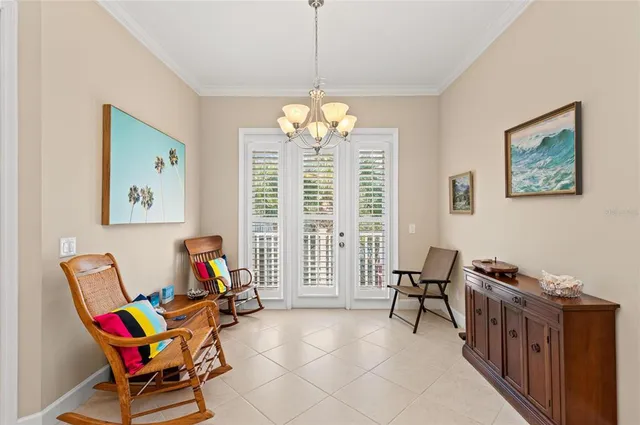 a view of a white house with a yard and potted plants