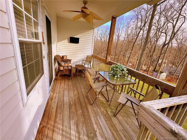 a view of a balcony with chairs and wooden floor