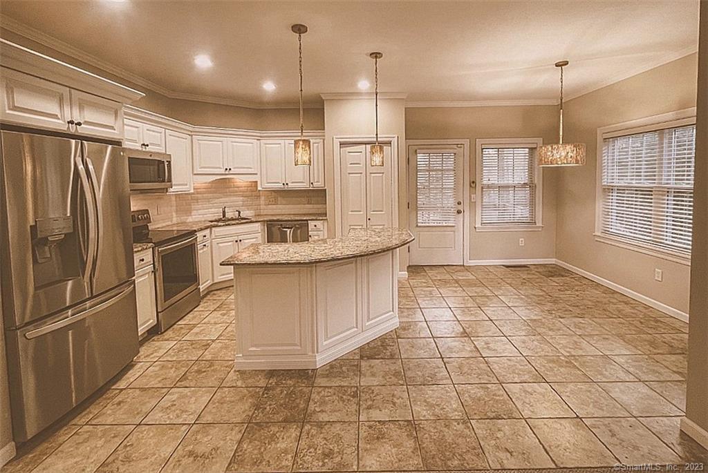 38 Canfield Drive Shelton, CT 06484 - Photo 5 of 29 a large kitchen with granite countertop a stove a refrigerator a oven and a sink with granite countertops