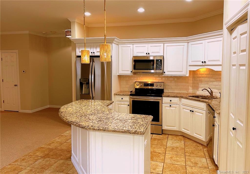 38 Canfield Drive Shelton, CT 06484 - Photo 7 of 29 a kitchen with stainless steel appliances granite countertop a sink stove and refrigerator