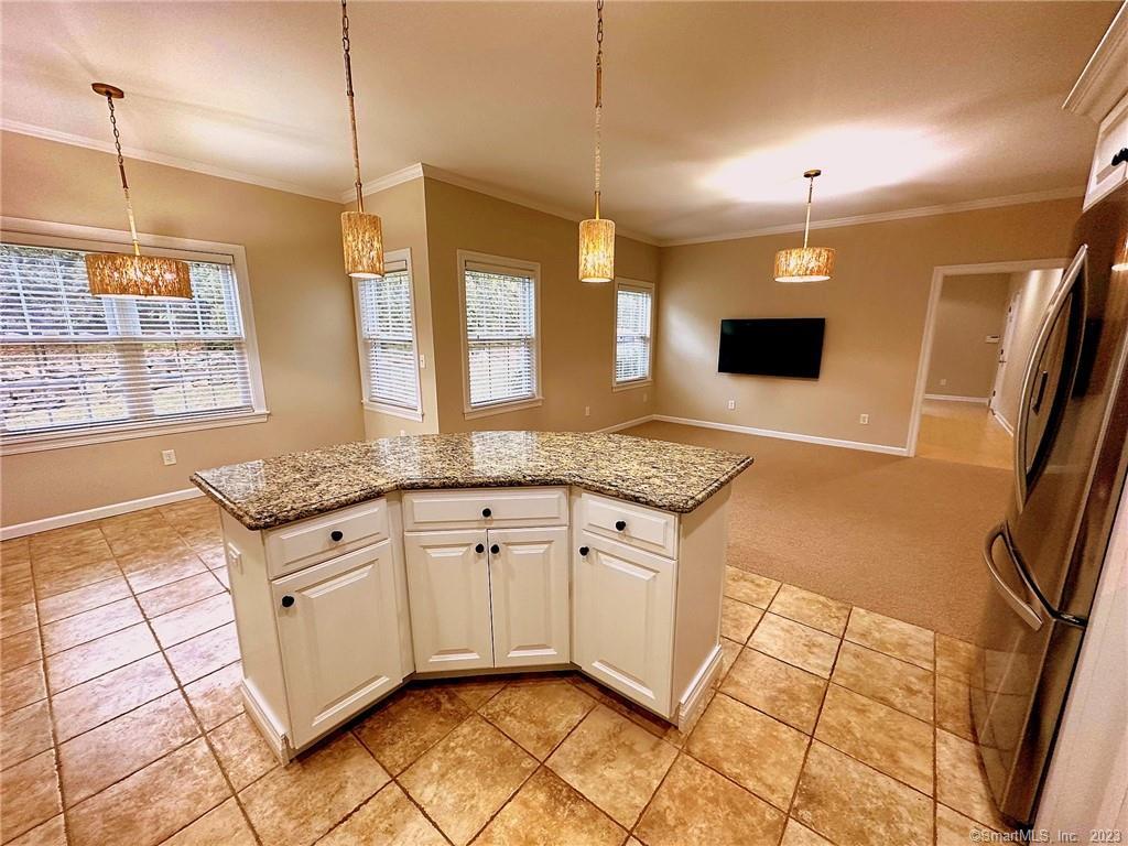 38 Canfield Drive Shelton, CT 06484 - Photo 9 of 29 a kitchen with granite countertop a sink and a stove top oven