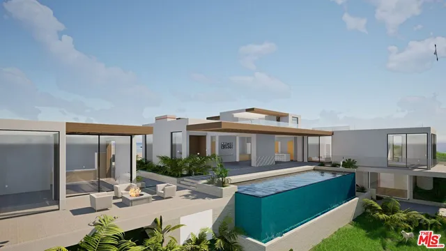 a view of a house with a yard deck and furniture