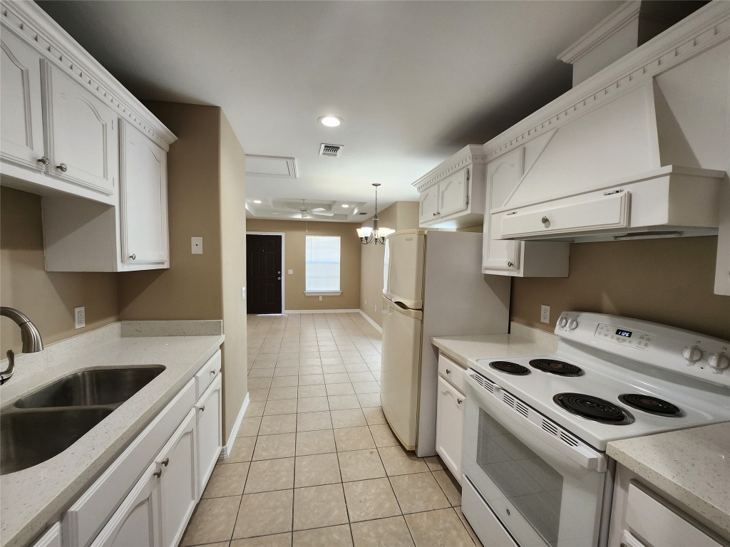 7609 Villa Rama S Street, Unit 4 Mission, TX 78572 - Photo 4 of 11 a kitchen that has a sink and a stove