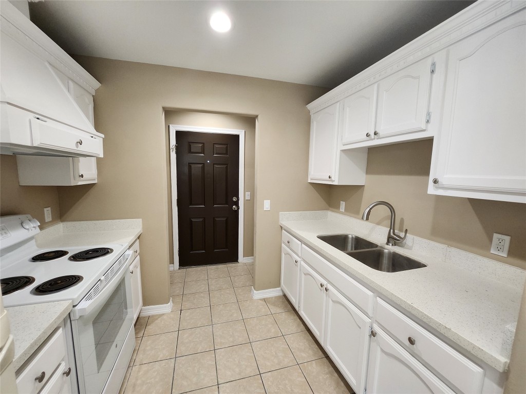 7609 Villa Rama S Street, Unit 4 Mission, TX 78572 - Photo 5 of 11 a kitchen with white cabinets a sink and white appliances
