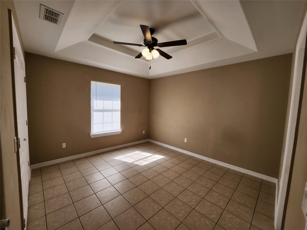 7609 Villa Rama S Street, Unit 4 Mission, TX 78572 - Photo 6 of 11 an empty room with windows and fan
