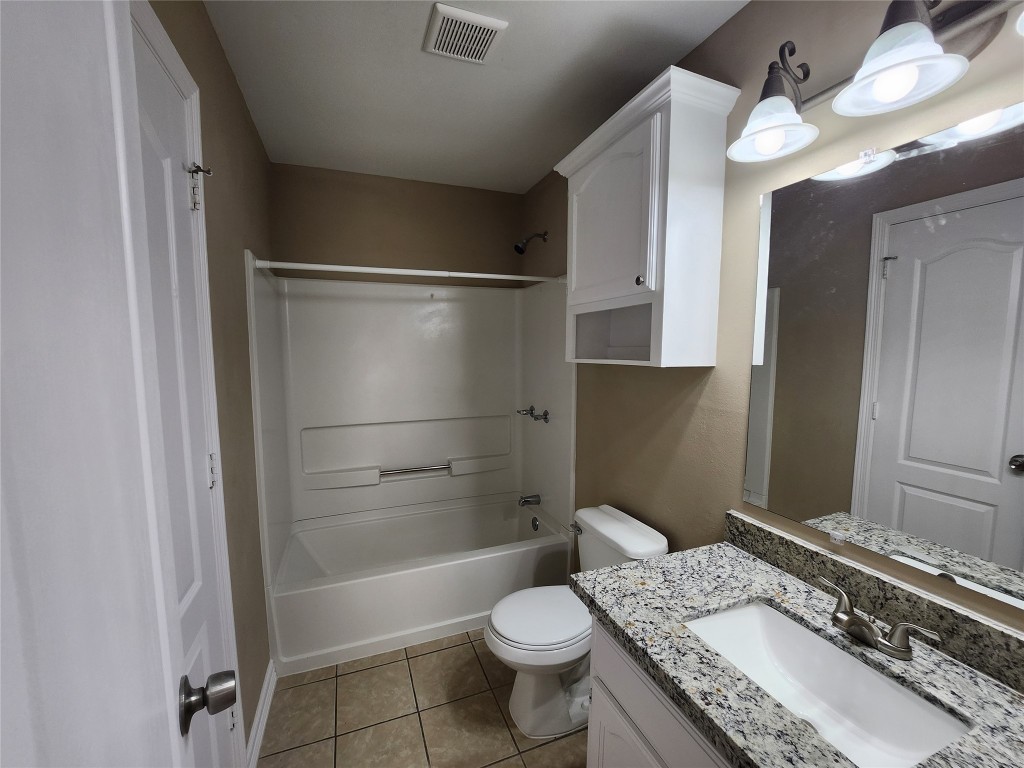 7609 Villa Rama S Street, Unit 4 Mission, TX 78572 - Photo 9 of 11 a bathroom with a granite countertop sink toilet and shower