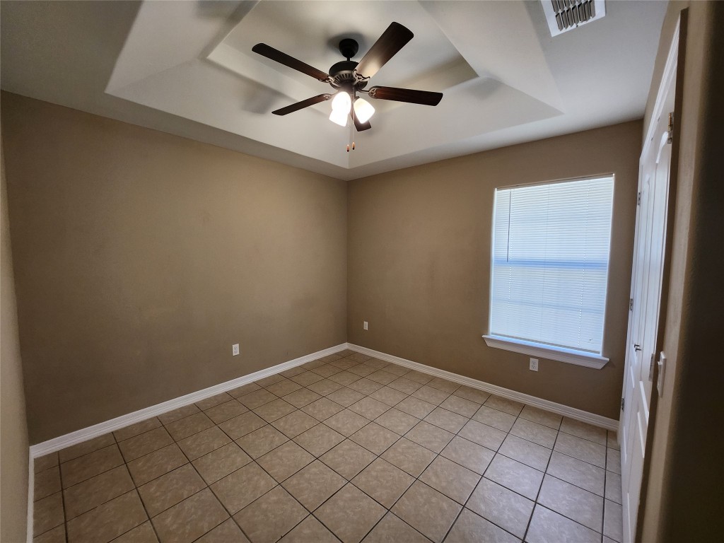 7609 Villa Rama S Street, Unit 4 Mission, TX 78572 - Photo 10 of 11 an empty room with ceiling fan and window