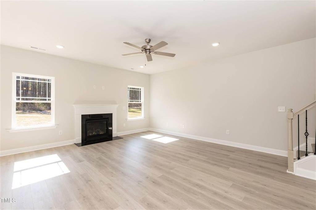 654 Bald Ridge Circle Demorest, GA 30535 - Photo 11 of 22 an empty room with windows fireplace and a sink
