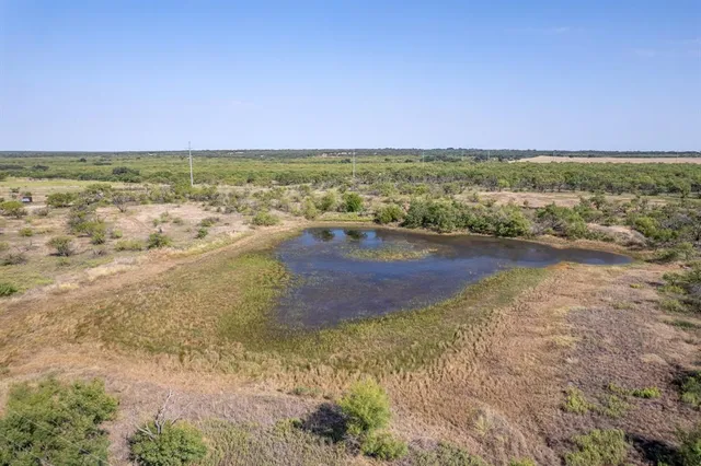 a view of a lake with beach and city