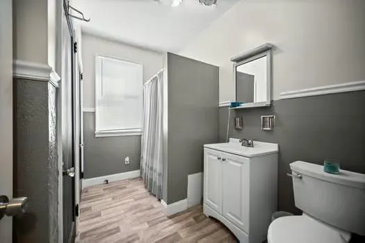 a bathroom with a toilet sink and mirror