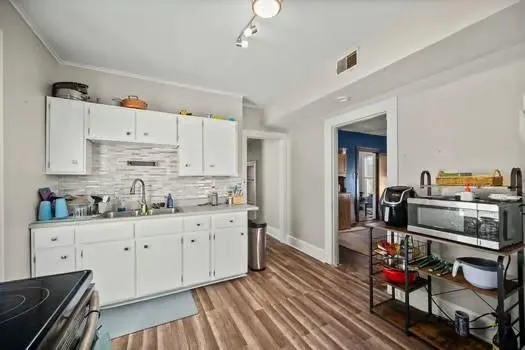 a kitchen with cabinets a sink and appliances