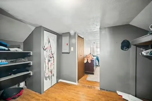 a view of a hallway with wooden floor and staircase