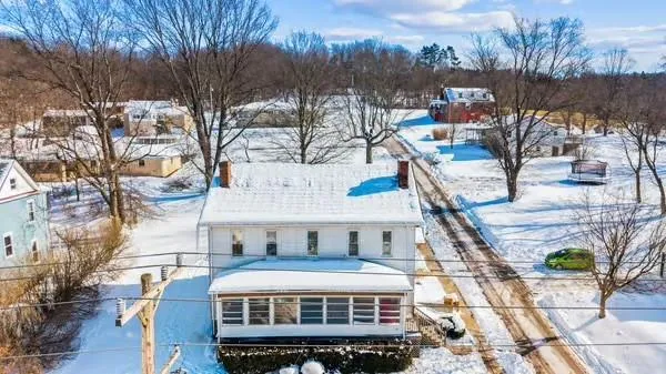 a view of a house with a snow in the background