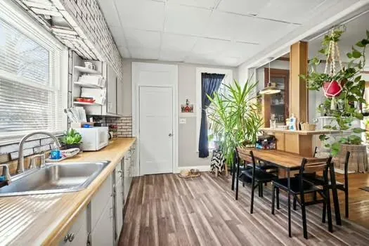 a kitchen with a table chairs stove and cabinets