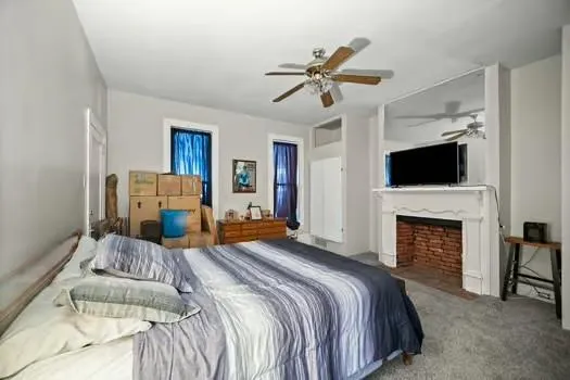 a bedroom with a bed and a fireplace