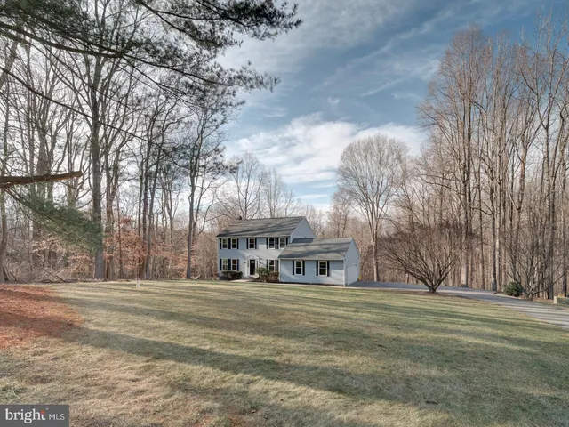 an empty room with wooden floor and fireplace