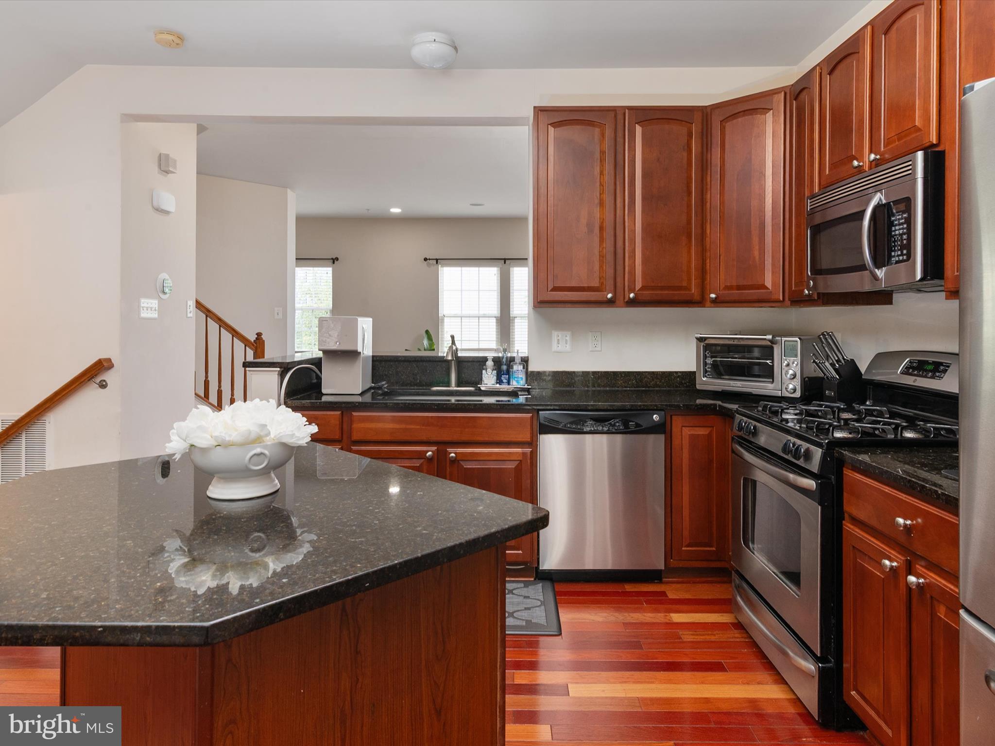 6888 Tasker Falls Elkridge, MD 21075 - Photo 18 of 47 a kitchen with stainless steel appliances granite countertop a sink stove and microwave