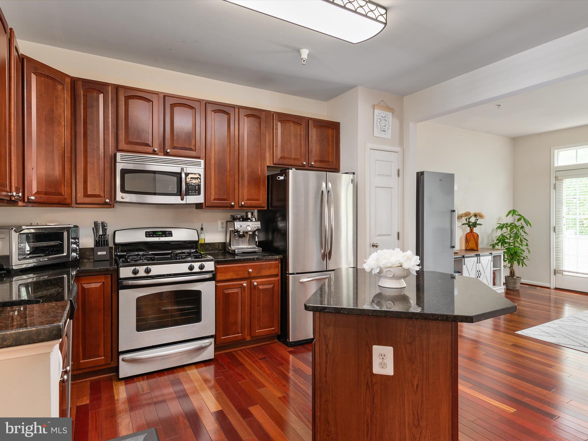 6888 Tasker Falls Elkridge, MD 21075 - Photo 19 of 47 a kitchen with wooden cabinets and stainless steel appliances
