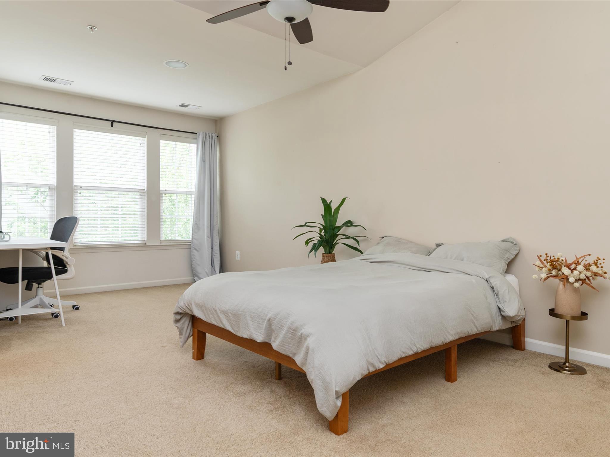 6888 Tasker Falls Elkridge, MD 21075 - Photo 28 of 47 a spacious bedroom with a bed and a table chair