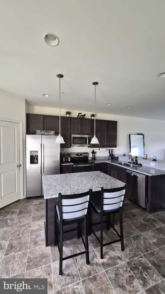 2488 Westwind Boulevard Cambridge, MD 21613 - Photo 15 of 32 a kitchen with a table and chairs in it