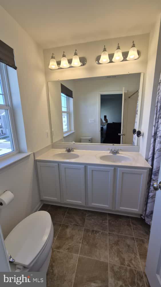 2488 Westwind Boulevard Cambridge, MD 21613 - Photo 21 of 32 a bathroom with a toilet sink and mirror