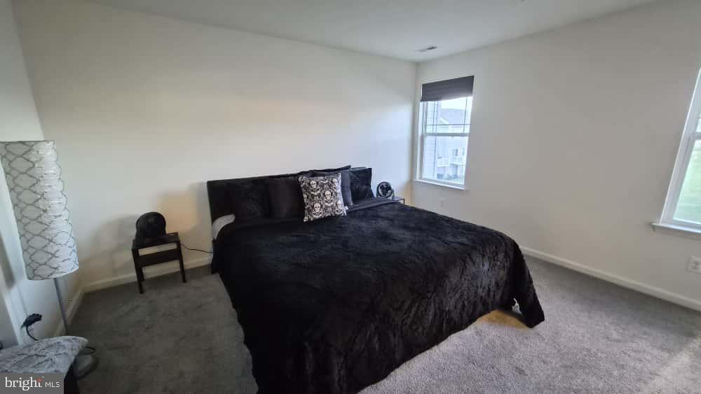 2488 Westwind Boulevard Cambridge, MD 21613 - Photo 23 of 32 a bedroom with a bed and a window