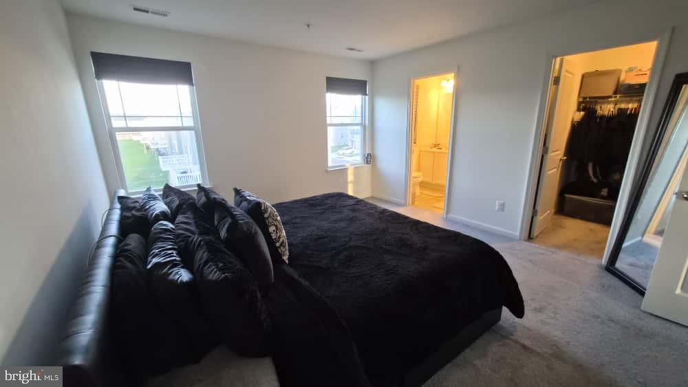 2488 Westwind Boulevard Cambridge, MD 21613 - Photo 24 of 32 a bed room with a bed and a mirror