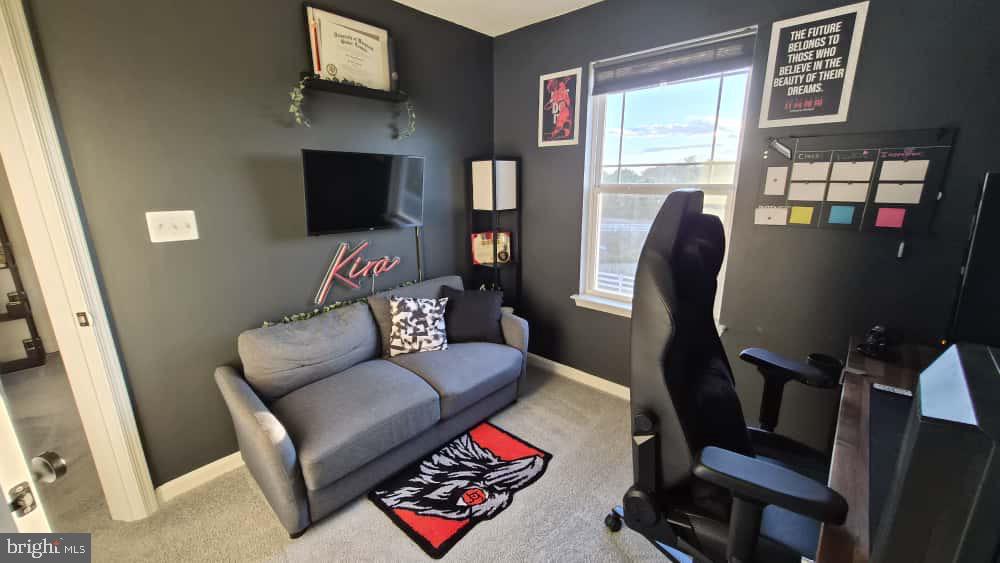 2488 Westwind Boulevard Cambridge, MD 21613 - Photo 26 of 32 a living room with furniture a flat screen tv and a window