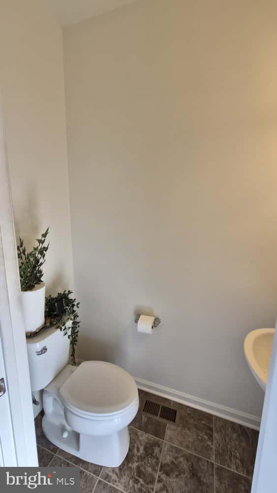 2488 Westwind Boulevard Cambridge, MD 21613 - Photo 7 of 32 a white toilet sitting next to a shower