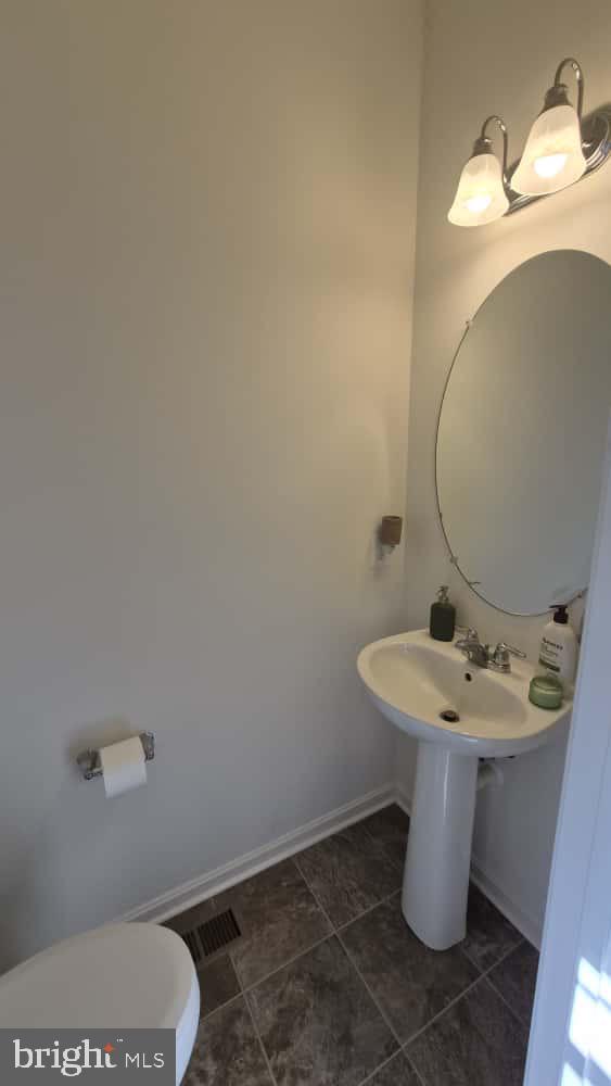 2488 Westwind Boulevard Cambridge, MD 21613 - Photo 8 of 32 a bathroom with a sink mirror and toilet