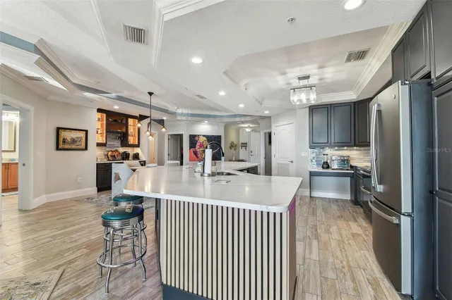 a utility room with dryer washer and a view of living room