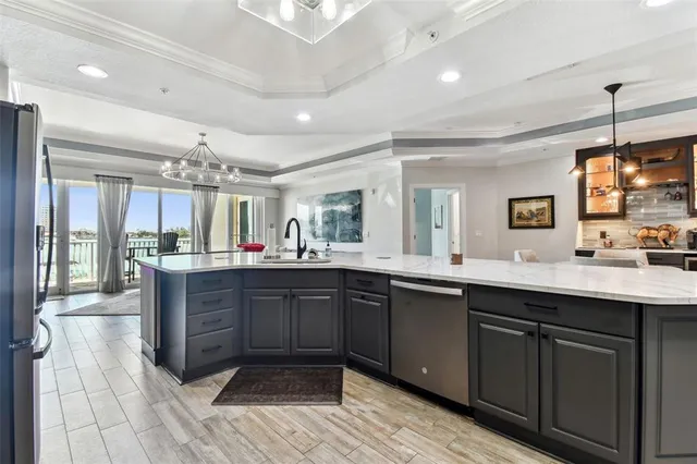 a living room with a bed and a walk in closet with wooden floor