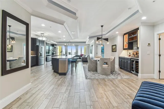 a kitchen with cabinets stainless steel appliances a sink and dishwasher with wooden floor