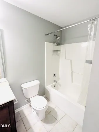 a white toilet sitting next to a bath tub shower