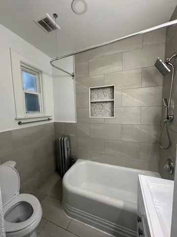 a bathroom with a toilet and a bathtub