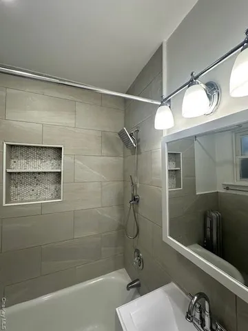a bathroom with a shower and a sink