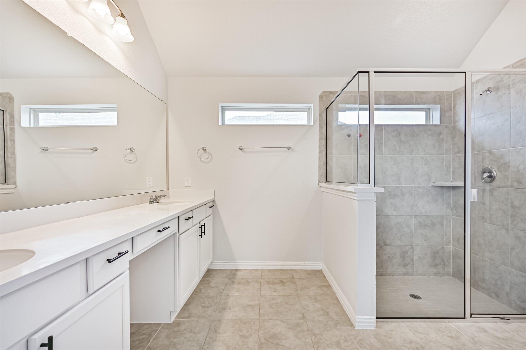 7019 Terra Drive Manvel, TX 77578 - Photo 34 of 41 a bathroom with a shower sink and mirror