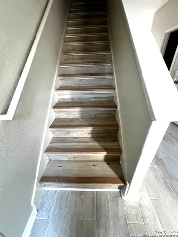 a bathroom with a sink a toilet a mirror and shower