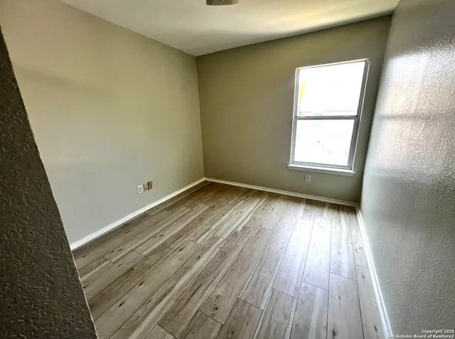 a view of a room with wooden floor