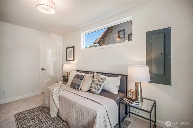 a bedroom with a bed and a lamp on table