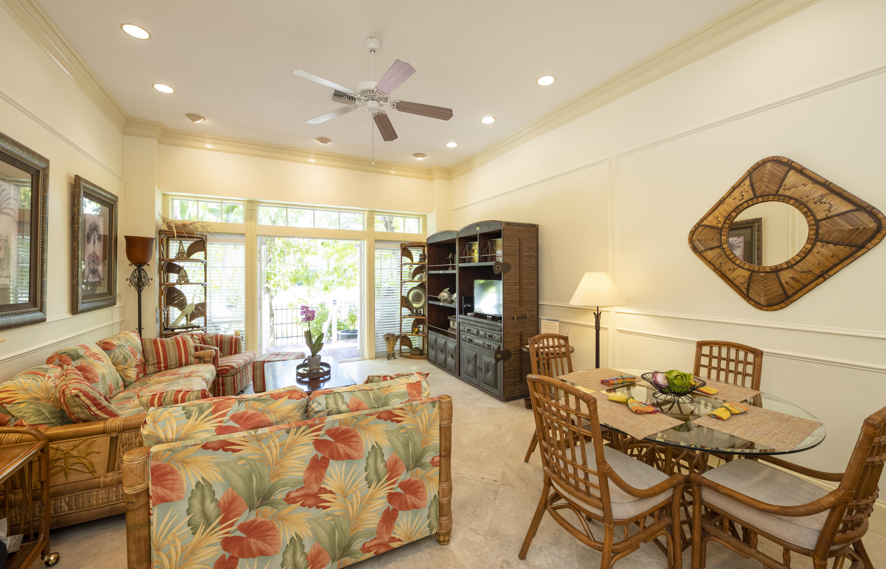 101 Front Street, Unit 5 Key West, FL 33040 - Photo 12 of 36 a bedroom with furniture a bed and a large mirror