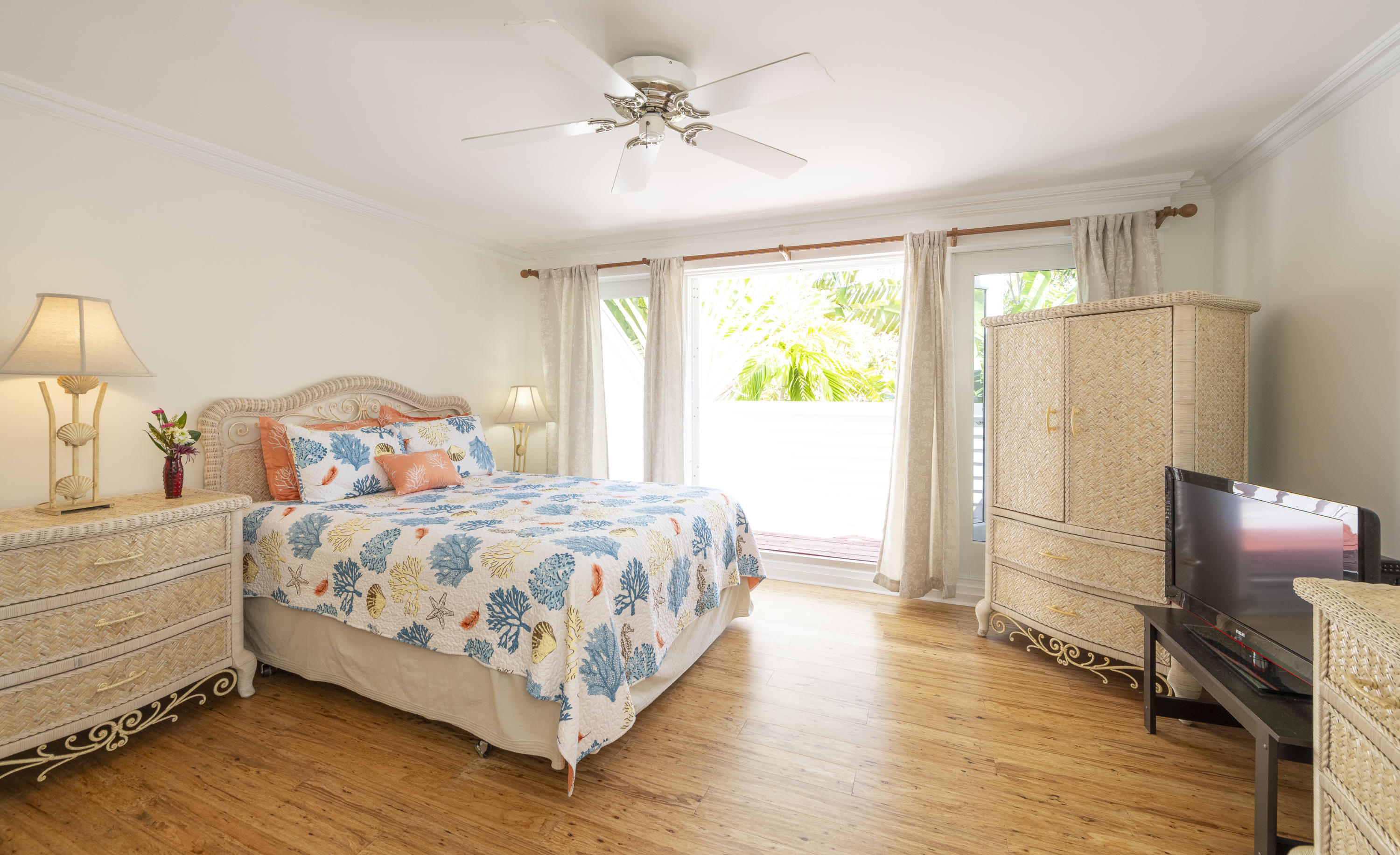 101 Front Street, Unit 5 Key West, FL 33040 - Photo 14 of 36 a bedroom with a bed and a chandelier