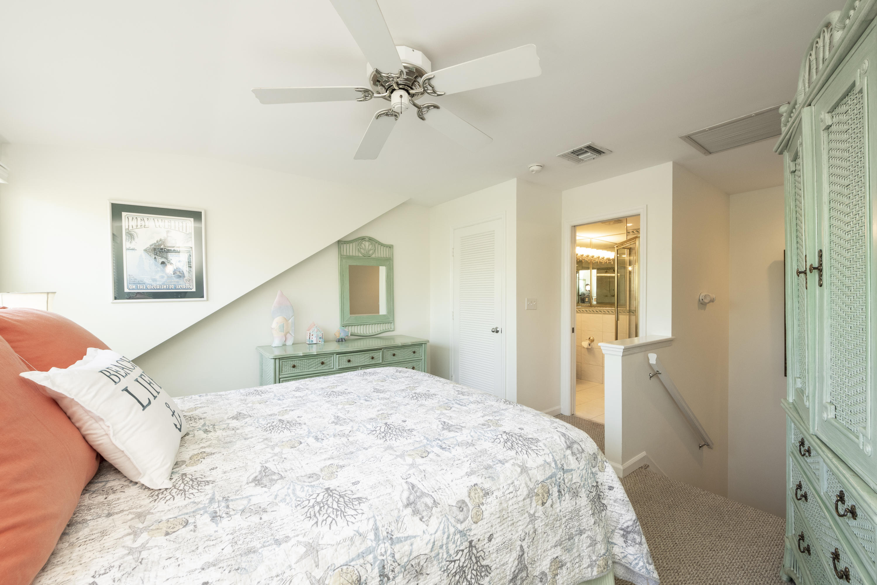 101 Front Street, Unit 5 Key West, FL 33040 - Photo 21 of 36 a bedroom with a large bed and a chandelier